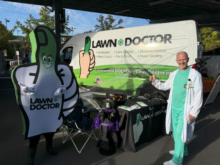 Owner Steve at a community Trunk-or-Treat event with the Lawn Doctor mascot
